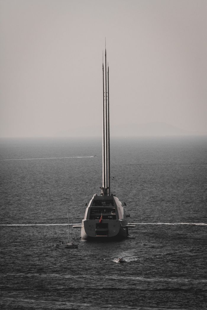 services-02 Majestic yacht sailing in the tranquil waters near Capri, Italy, under a moody sky.